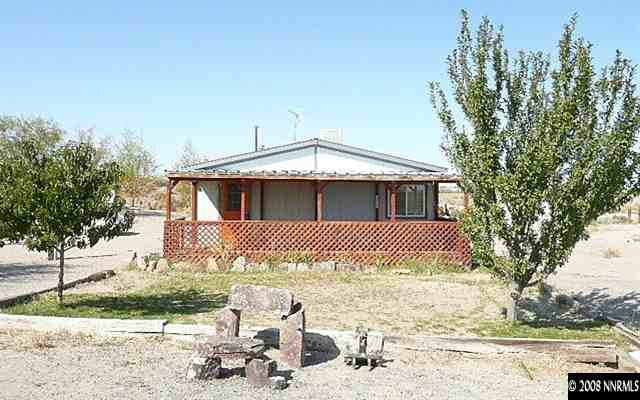 7067 Milburn Lane Fallon, NV 89406 - Photo 2 of 9 a front view of a house with a yard