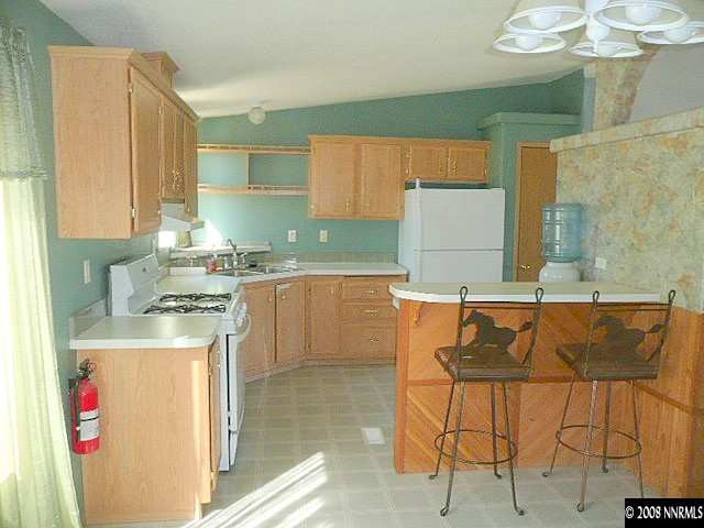7067 Milburn Lane Fallon, NV 89406 - Photo 3 of 9 a kitchen with a sink a stove and chairs