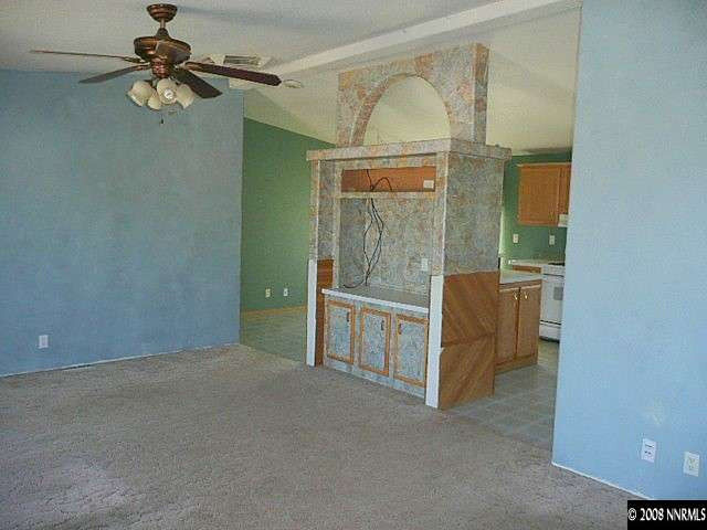 7067 Milburn Lane Fallon, NV 89406 - Photo 4 of 9 an empty room with chandelier fan and windows