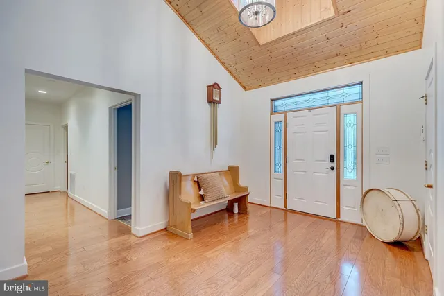 a kitchen with a stove a sink a counter top space and living room view