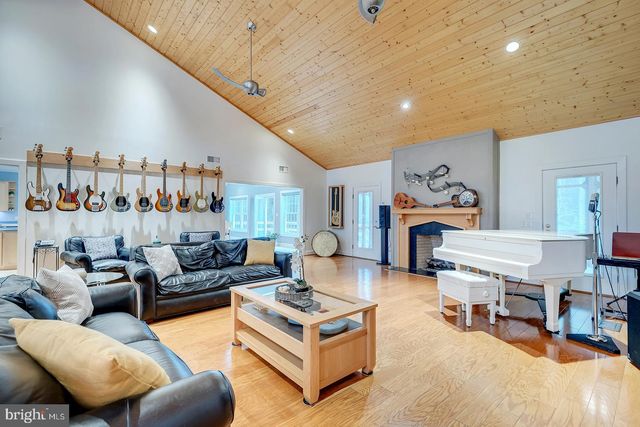 a kitchen with stainless steel appliances granite countertop a sink window and cabinets