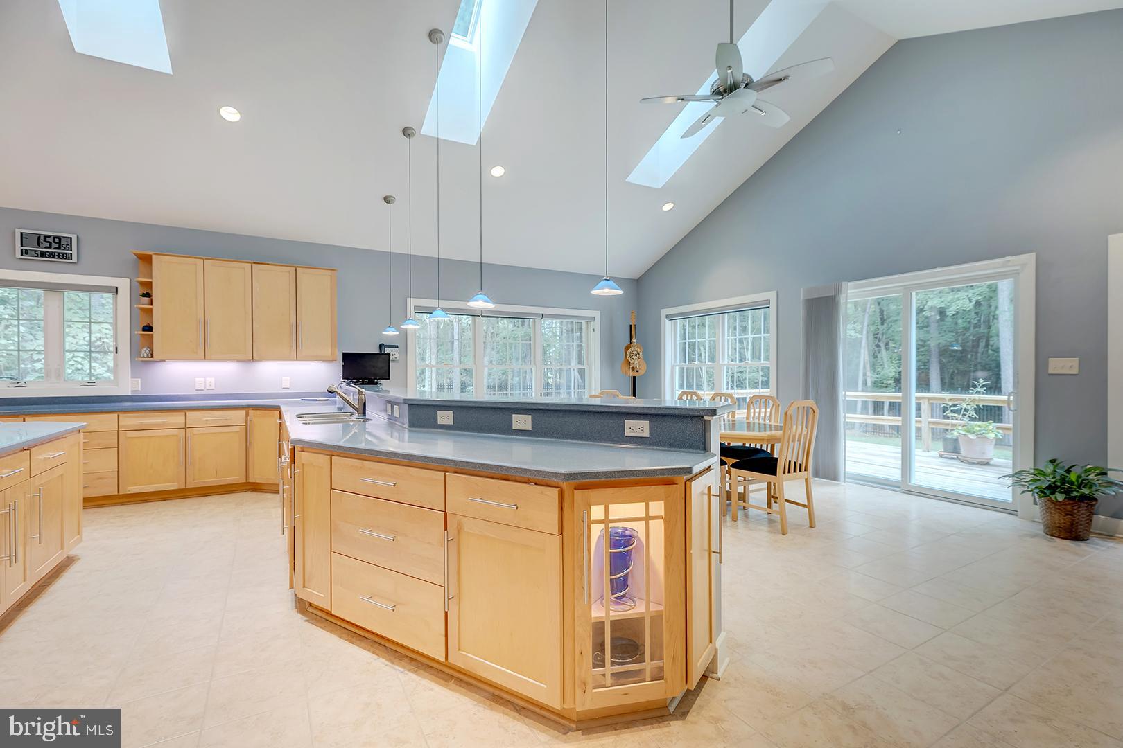 22095 Wilson Road Georgetown, DE 19947 - Photo 28 of 137 a kitchen with a stove a sink a counter top space and living room view