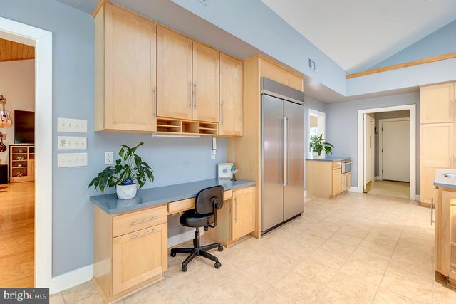 a view of a hallway with paintings on the wall