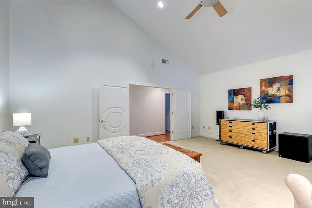 a front view of a house with a yard and green space