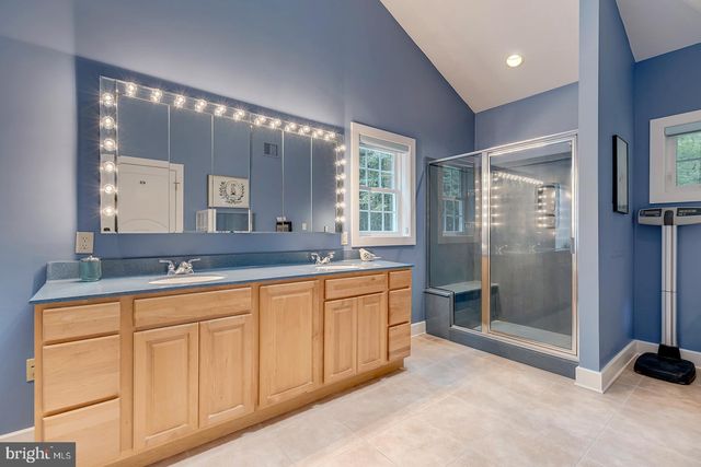 a view of a white house with a big yard