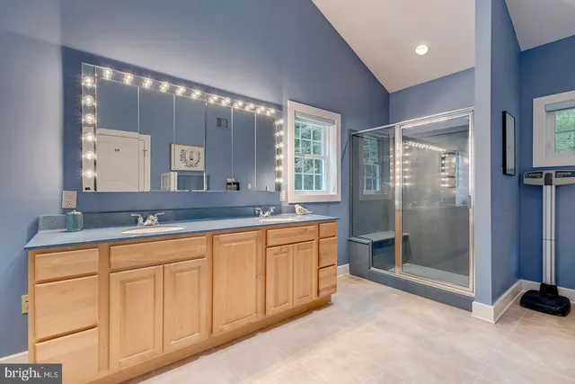 a view of a white house with a big yard