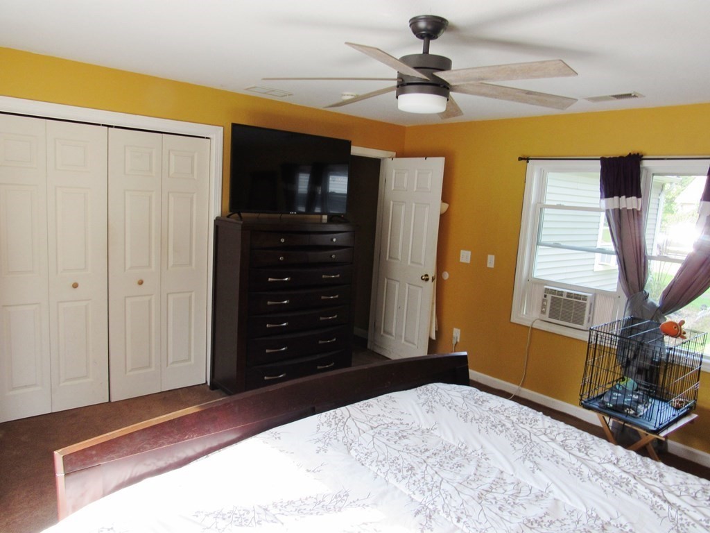 2028 East Street Three Rivers, MA 01080 - Photo 11 of 31 a bedroom with a bed and a chandelier