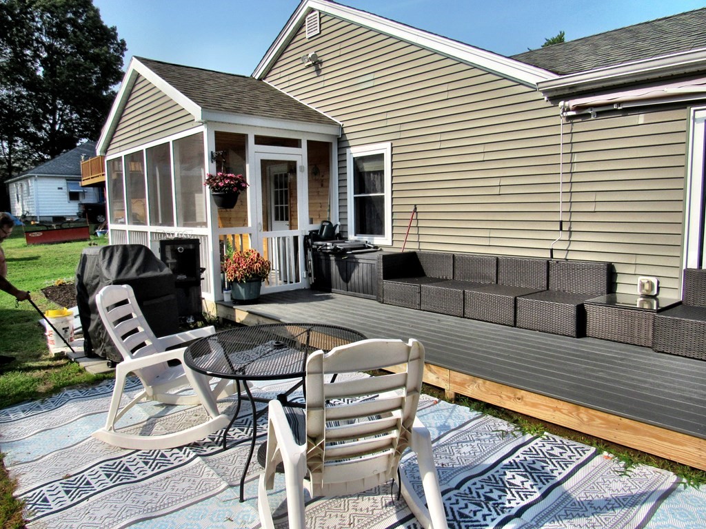 2028 East Street Three Rivers, MA 01080 - Photo 26 of 31 a view of a patio with table and chairs with wooden floor and fence
