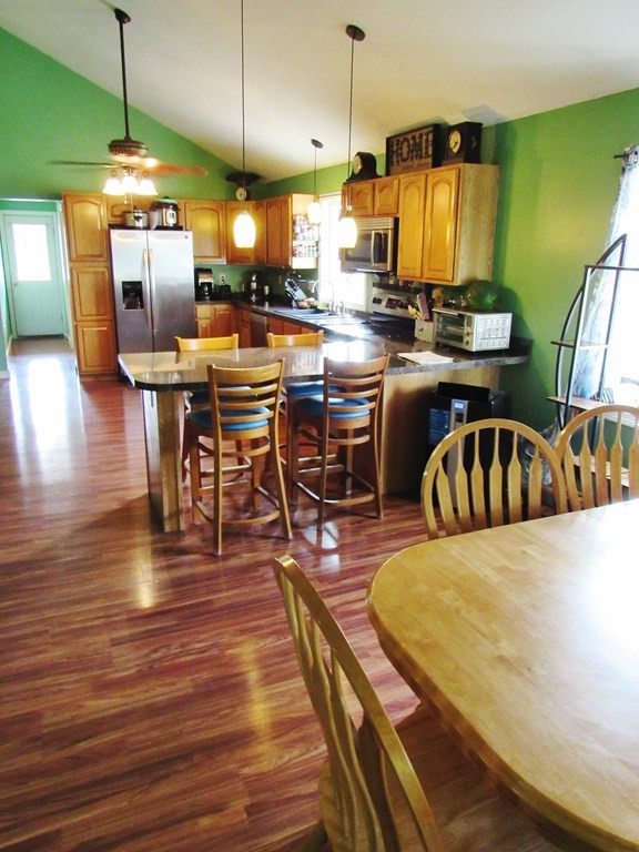 2028 East Street Three Rivers, MA 01080 - Photo 7 of 31 a view of a kitchen with dining room and wooden floor