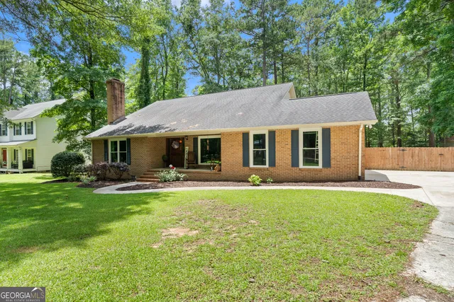 a front view of a house with a garden and porch