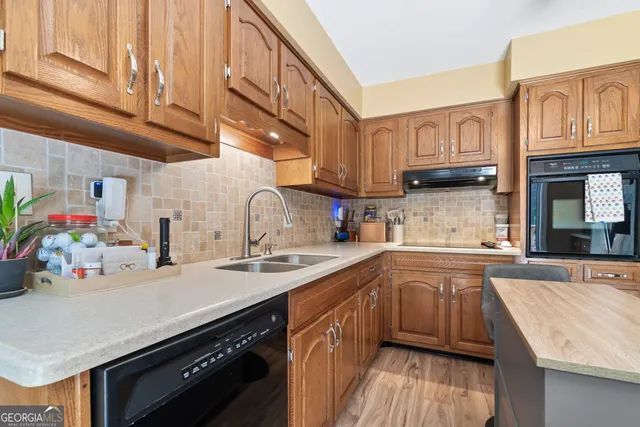 a kitchen with stainless steel appliances granite countertop a sink stove and cabinets