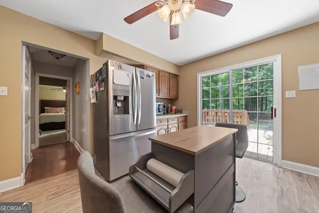 a kitchen with stainless steel appliances granite countertop a refrigerator a sink and a stove