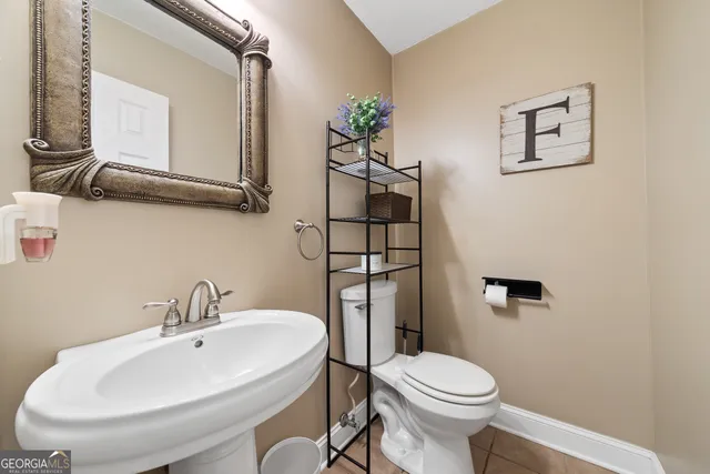 a bathroom with a sink mirror and toilet