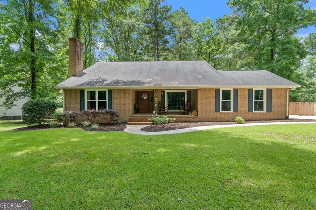 a front view of a house with yard patio and green space