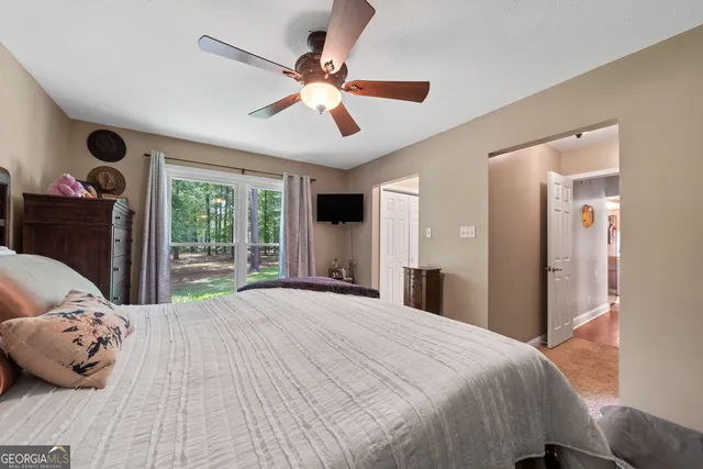 a bedroom with a large bed and a large window