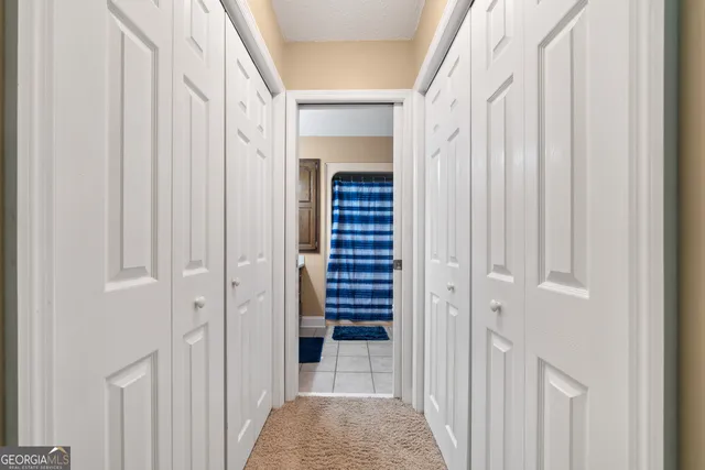 a view of a hallway with wooden floor and entryway