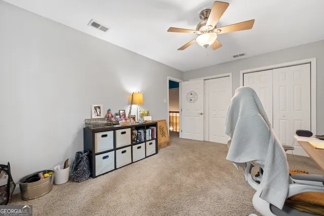 a view of a room with window and ceiling fan