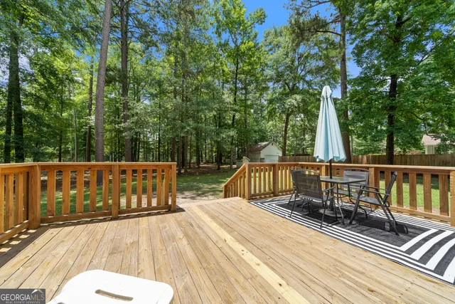 a view of balcony with wooden floor and outdoor seating