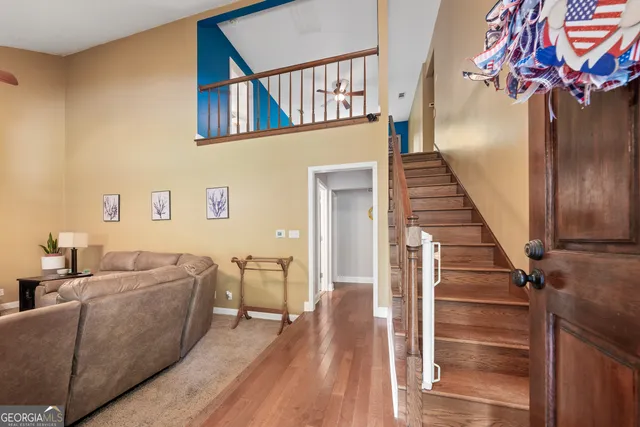 a living room with furniture and a stair