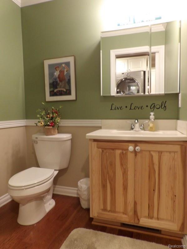357 Rabbit Run Road Carleton, MI 48117 - Photo 43 of 69 HALF BATH WITH CROWN MOLDING, DESIGNER PAINT COLOR, BEAUTIFUL CHERRY HICKORY HARDWOOD FLOOR + HICKORY RAISED-PANEL VANITY WITH ONE-PIECE MOLDED SINK!