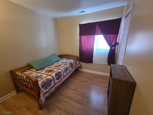 a bedroom with a bed lamp and a window