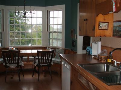 Undisclosed Address Falmouth, MA 02540 - Photo 11 of 13 a kitchen with a table chairs and window
