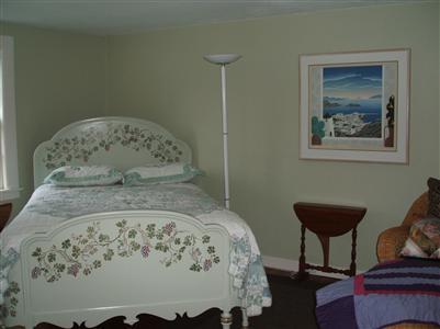 Undisclosed Address Falmouth, MA 02540 - Photo 8 of 13 a bed sitting in a bedroom next to a wooden cabinet