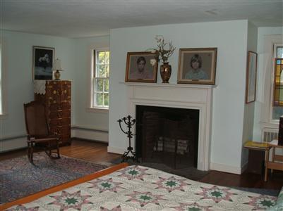Undisclosed Address Falmouth, MA 02540 - Photo 9 of 13 a living room with furniture and a fireplace