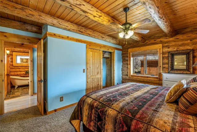 a bedroom with a bed and a large window with balcony view