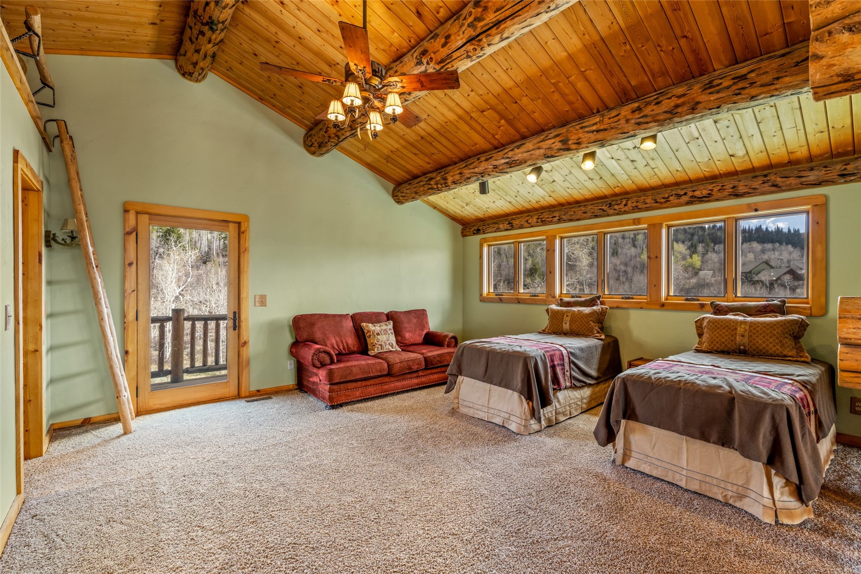 24110 Arapahoe Road Oak Creek, CO 80467 - Photo 24 of 39 a spacious bedroom with two beds and a chandelier