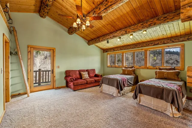 a spacious bedroom with two beds and a chandelier
