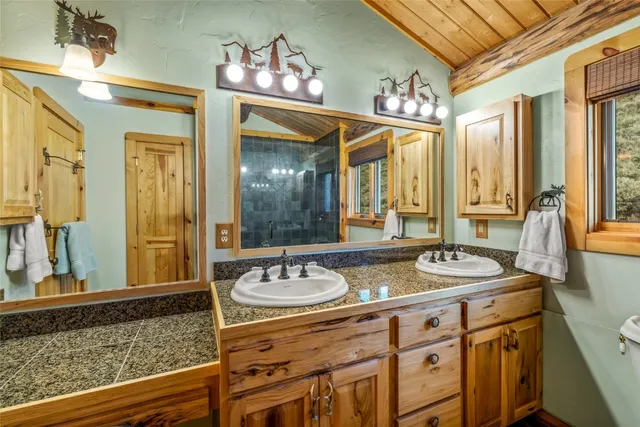 a bathroom with a sink double vanity and a mirror