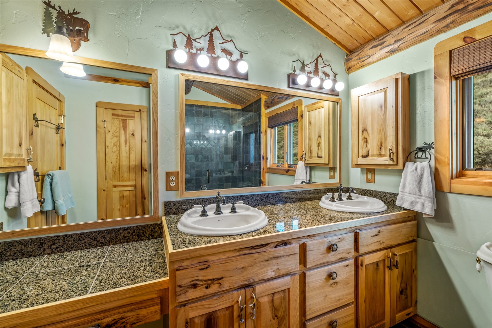 24110 Arapahoe Road Oak Creek, CO 80467 - Photo 27 of 39 a bathroom with a sink double vanity and a mirror
