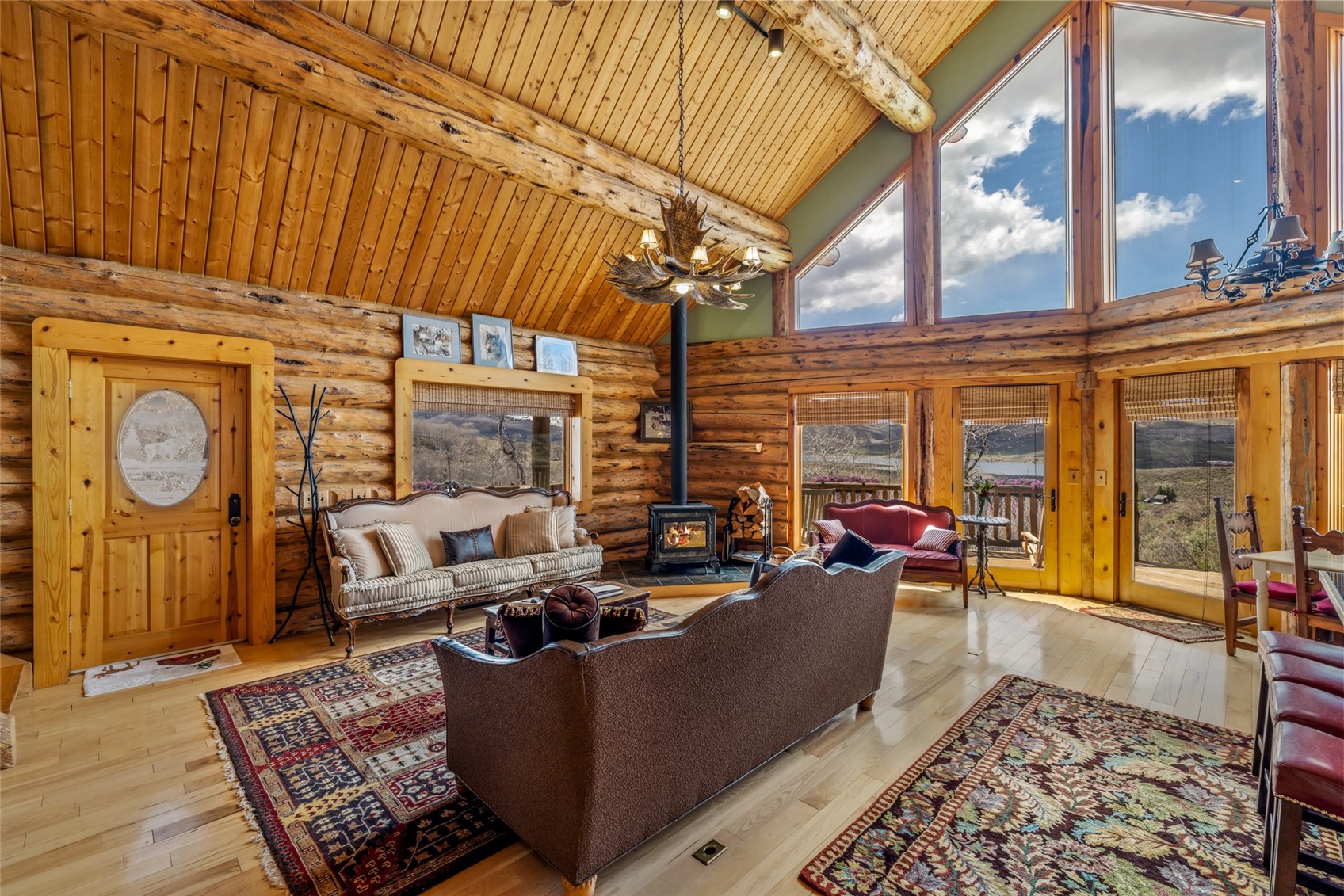 24110 Arapahoe Road Oak Creek, CO 80467 - Photo 10 of 39 a living room with furniture a rug a fireplace and windows