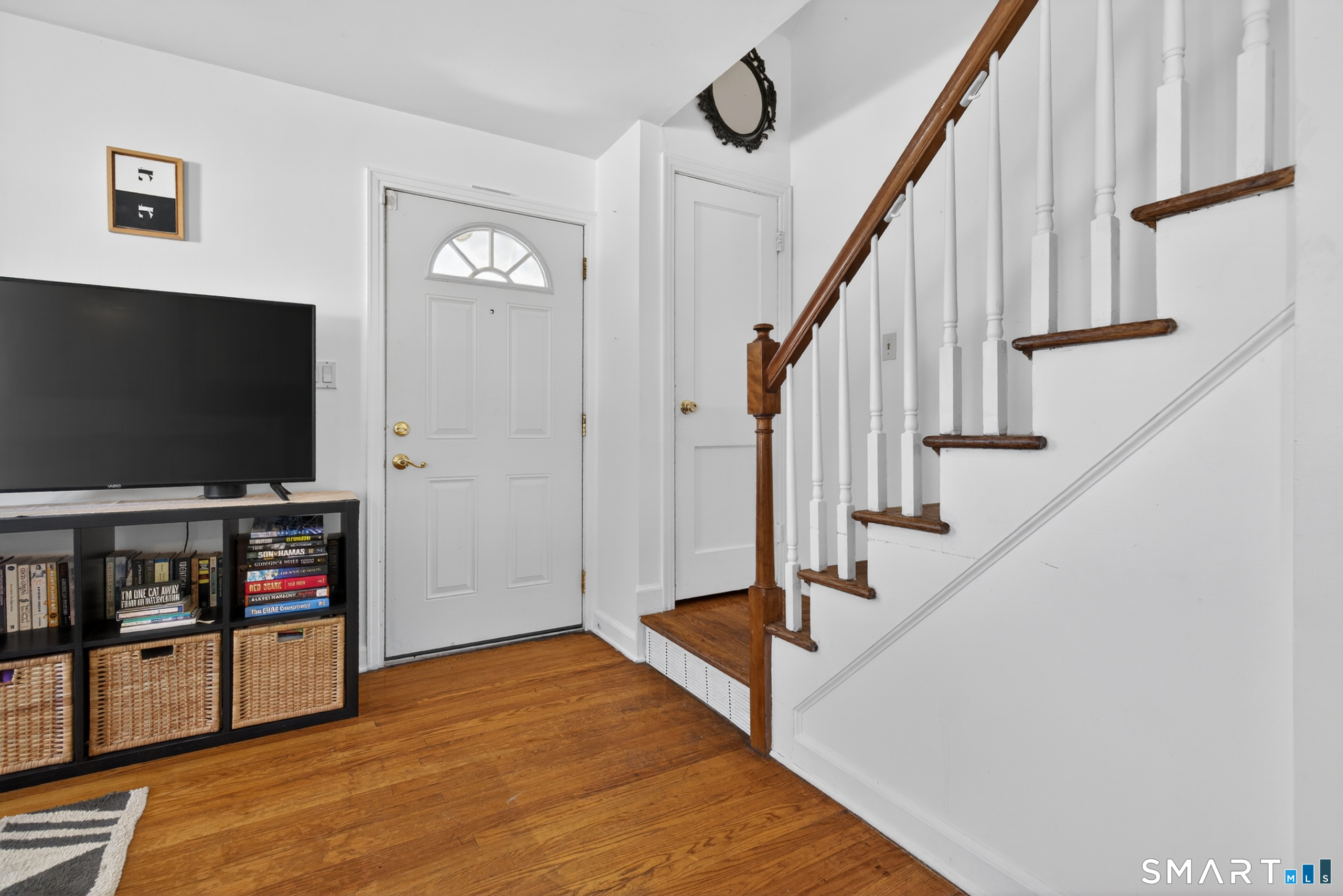 6 Welch Street Hamden, CT 06514 - Photo 11 of 23 a living room with wooden floor and a flat screen tv