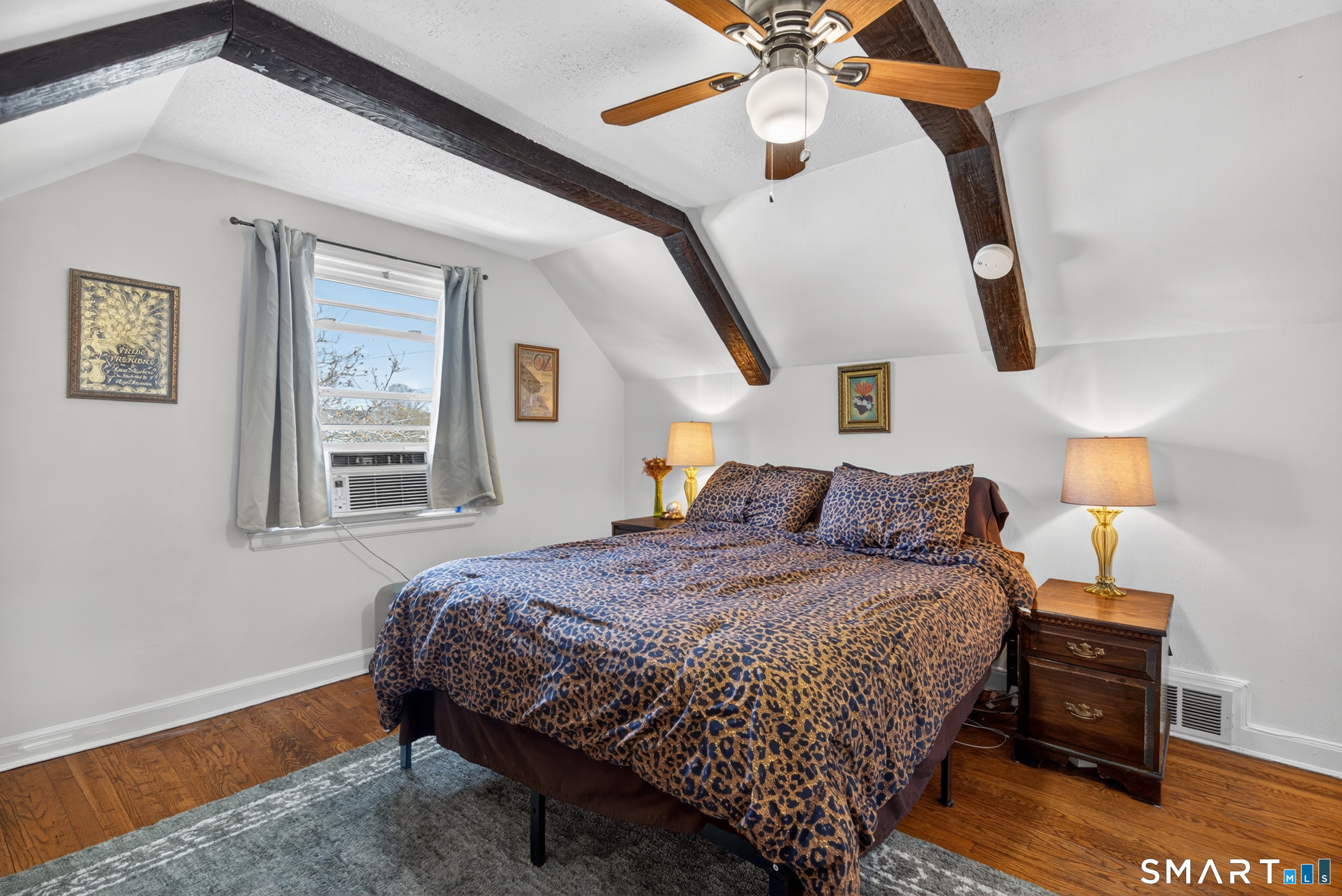 6 Welch Street Hamden, CT 06514 - Photo 6 of 23 a bedroom with a bed and a chandelier