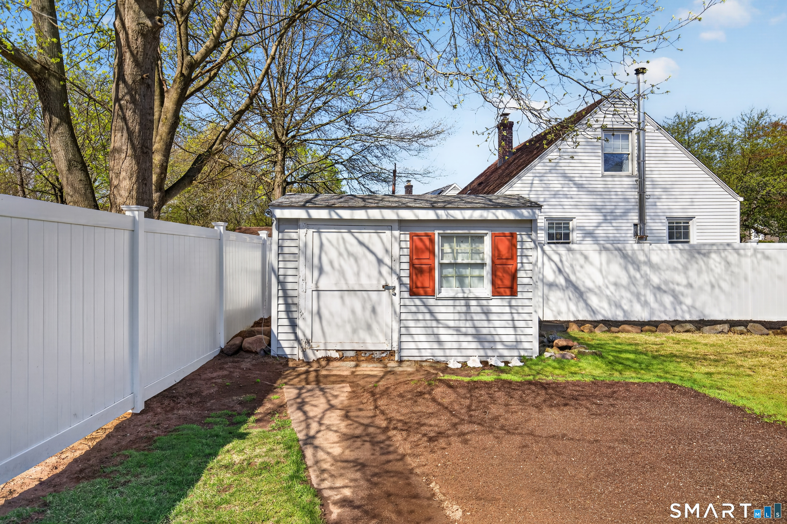 6 Welch Street Hamden, CT 06514 - Photo 9 of 23 a front view of a house with a garden and yard