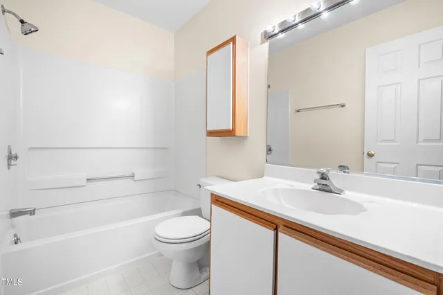 a view of a garden with lawn chairs under an umbrella