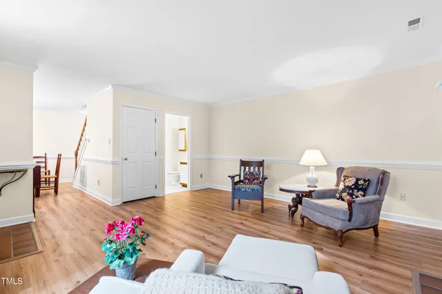 a living room with fireplace furniture and a wooden floor