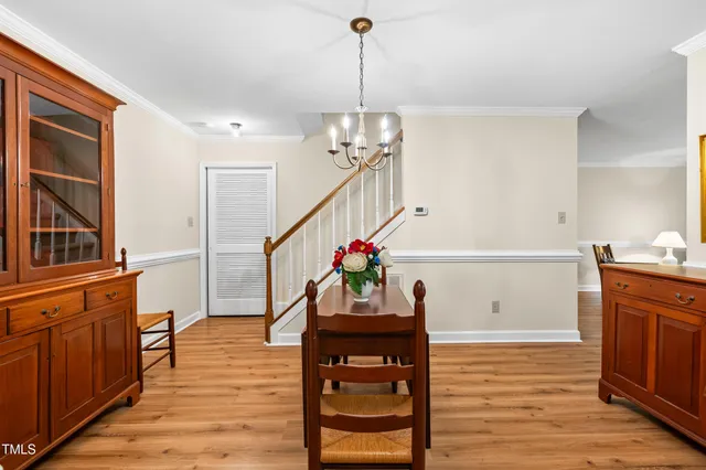 a kitchen with stainless steel appliances granite countertop a stove a sink and a refrigerator with wooden floors