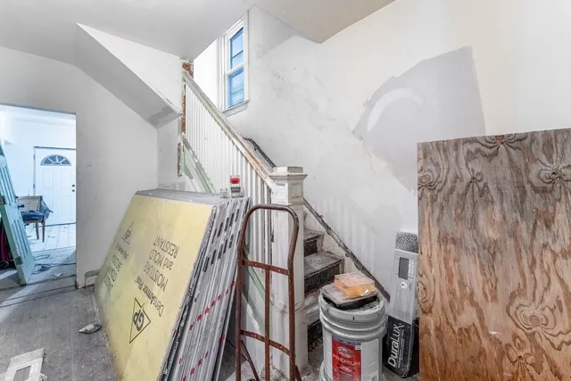 a view of a bedroom with furniture and workspace