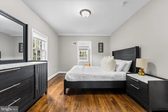 a bed sitting in a bedroom next to a window with lamp