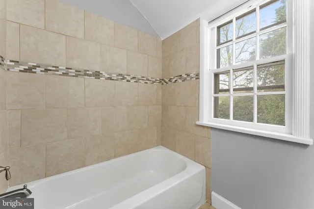 a bathroom with a bathtub and shower