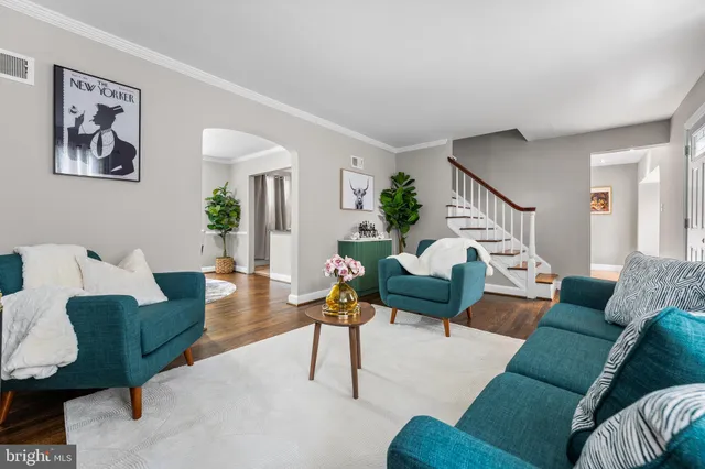a living room with furniture and a potted plant