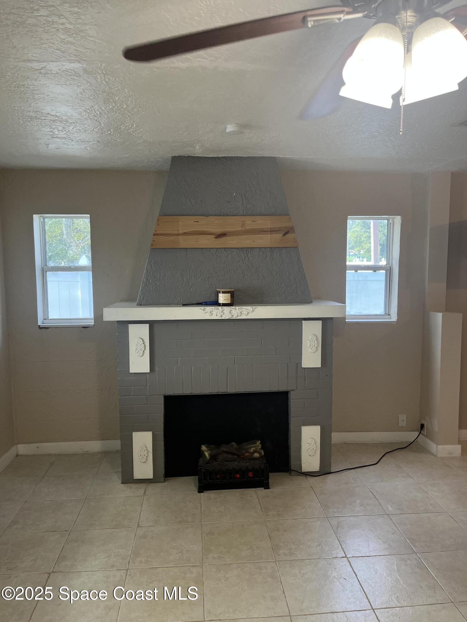 510 East Strawbridge Avenue, Unit BSALON Melbourne, FL 32901 - Photo 2 of 11 a living room with furniture and a fireplace