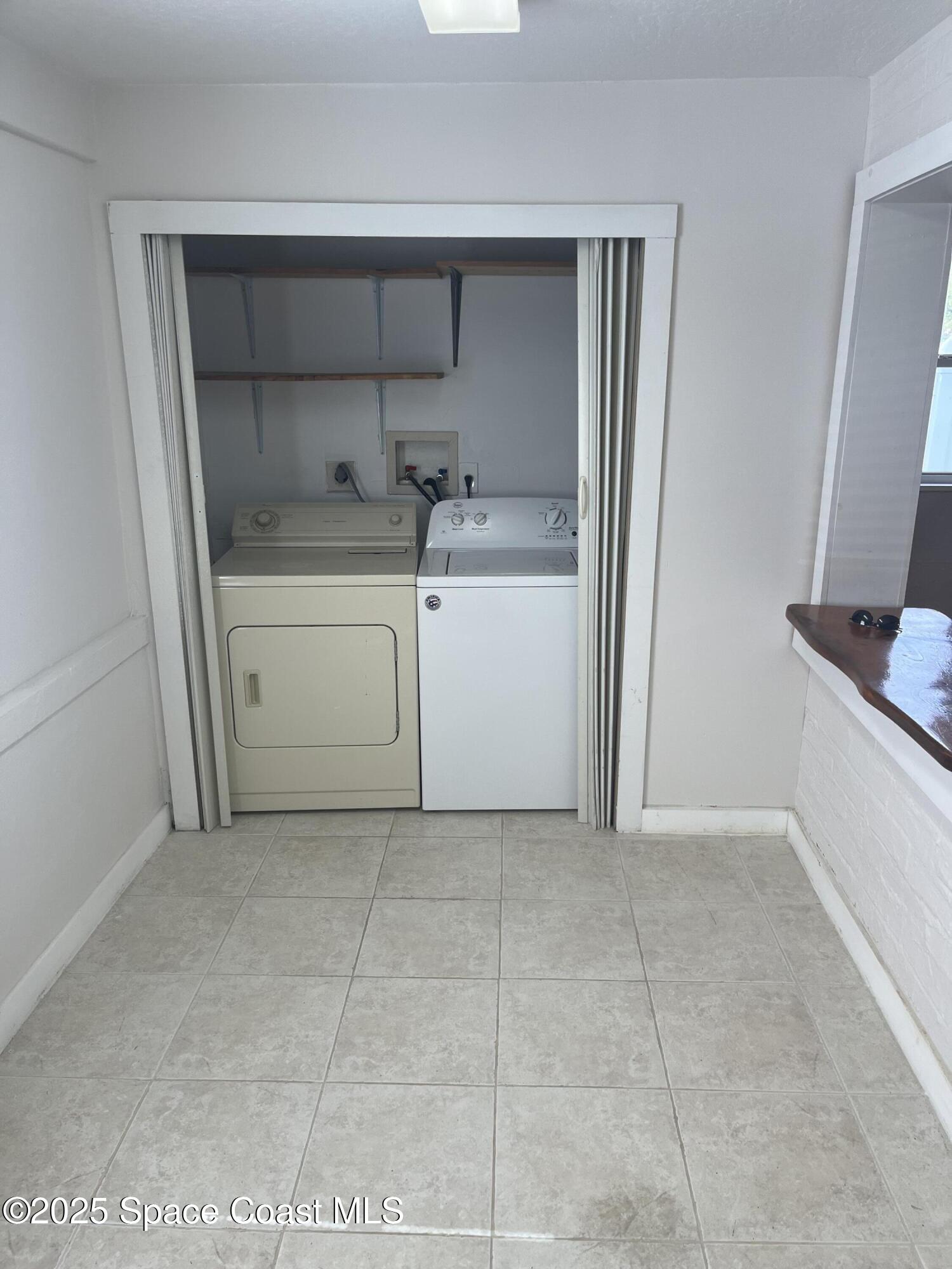 510 East Strawbridge Avenue, Unit BSALON Melbourne, FL 32901 - Photo 3 of 11 a utility room with cabinets washer and dryer
