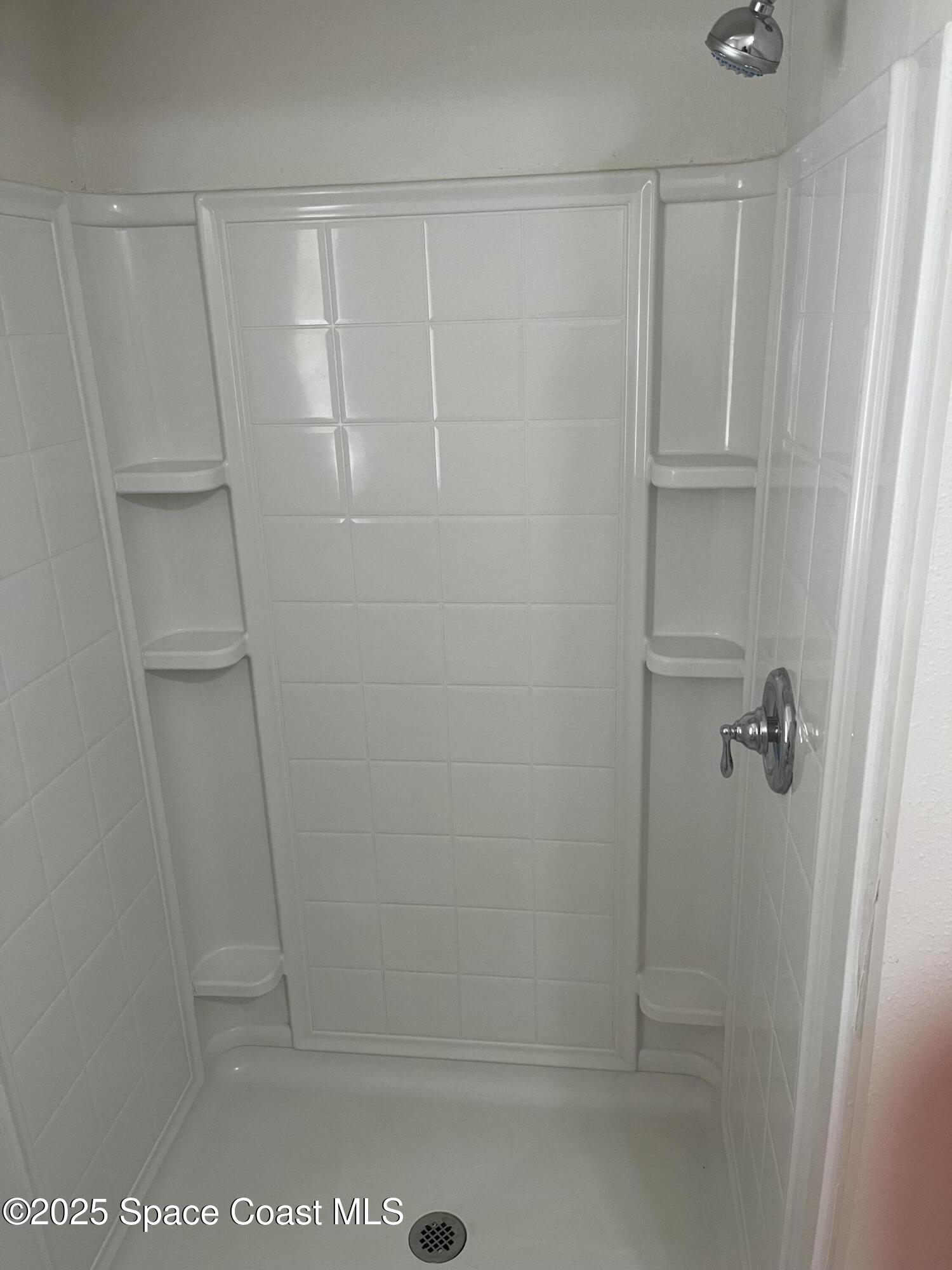 510 East Strawbridge Avenue, Unit BSALON Melbourne, FL 32901 - Photo 10 of 11 a bathroom with a glass shower door