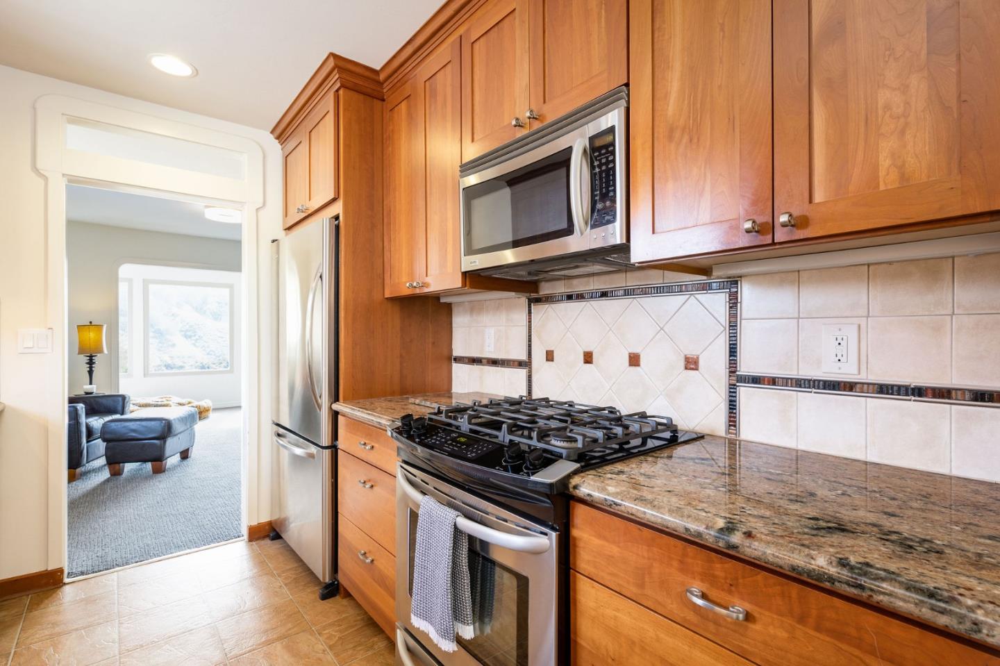 1079 Park Pacifica Avenue Pacifica, CA 94044 - Photo 13 of 43 a kitchen with stainless steel appliances granite countertop a stove and a microwave
