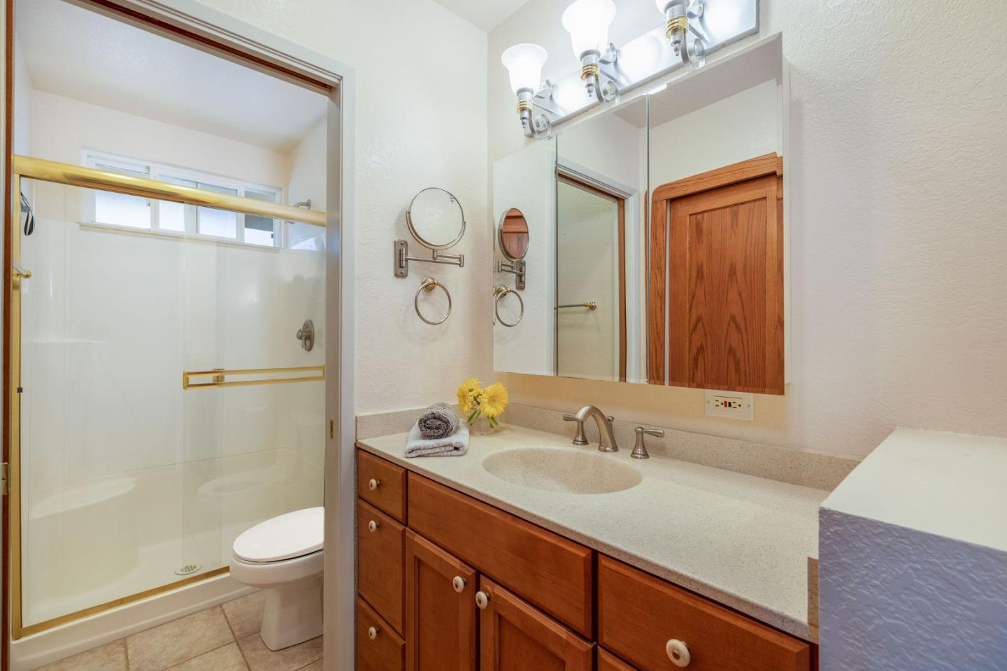 1079 Park Pacifica Avenue Pacifica, CA 94044 - Photo 19 of 43 a bathroom with a granite countertop sink toilet and shower