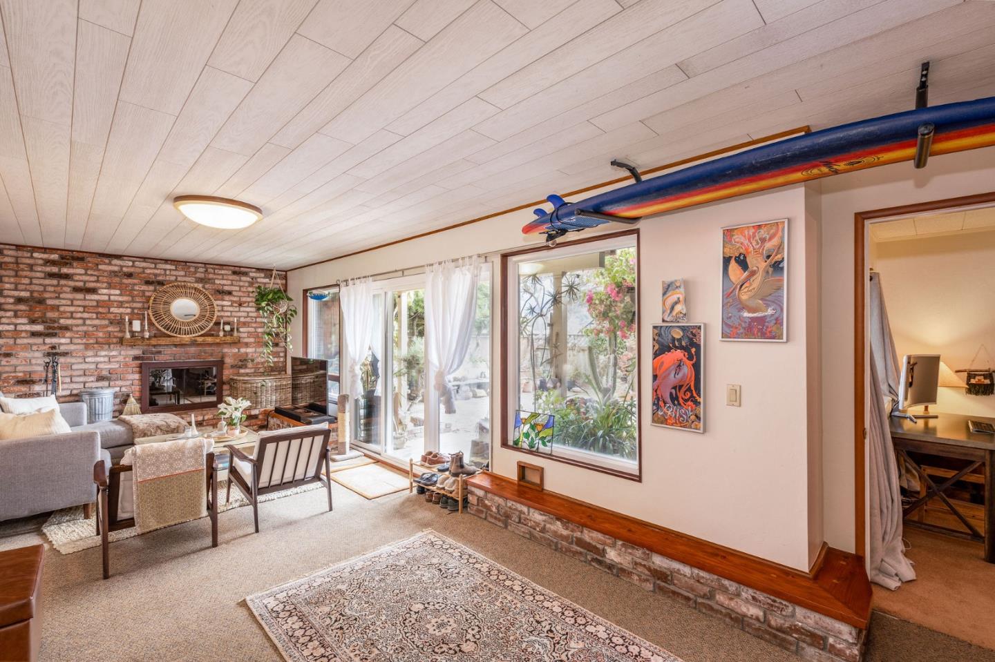 1079 Park Pacifica Avenue Pacifica, CA 94044 - Photo 30 of 43 a living room with furniture a rug and a large window